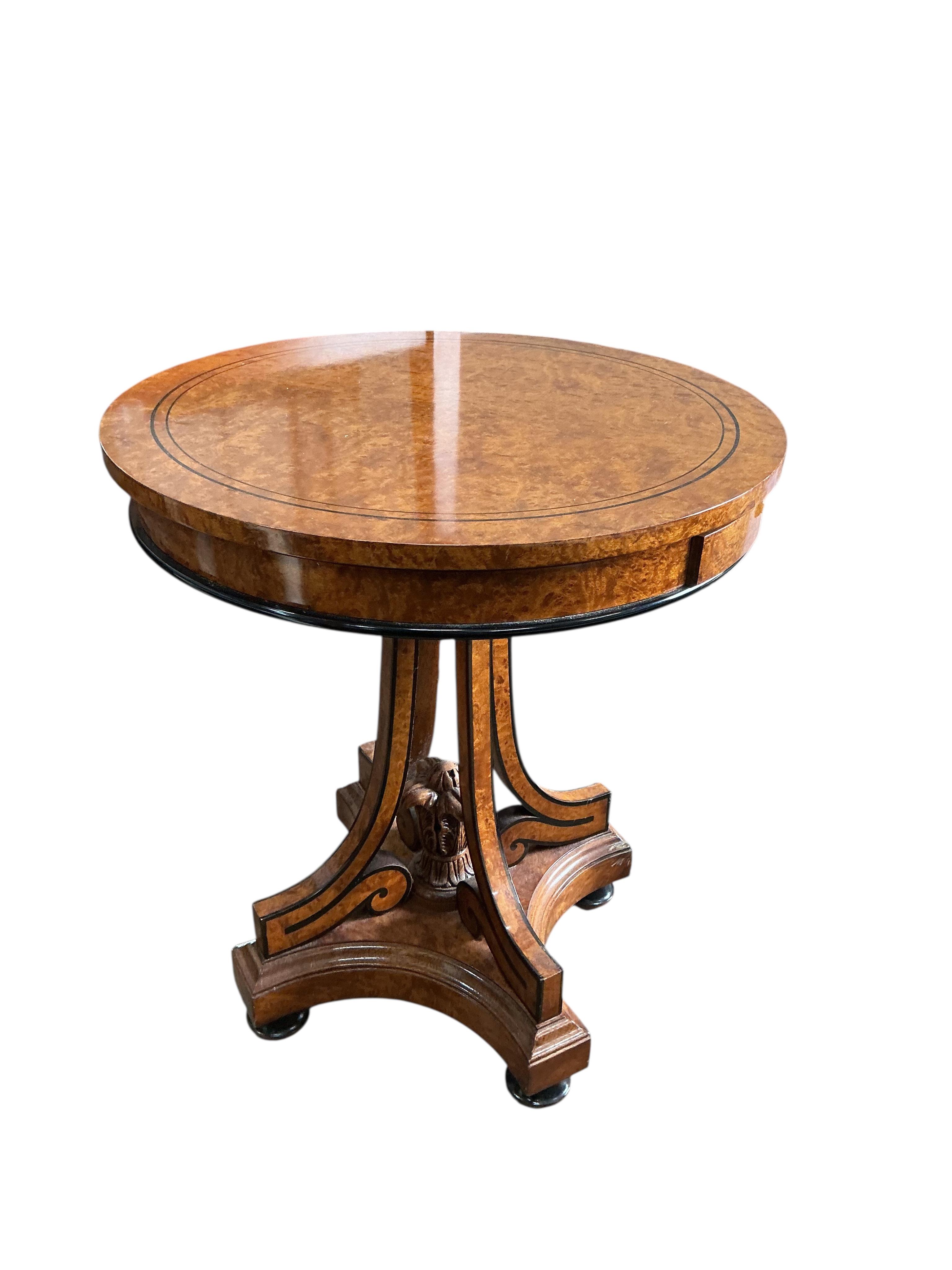 A Regency style part ebonised bird's eye maple circular centre table, diameter 64cm, height 74cm
